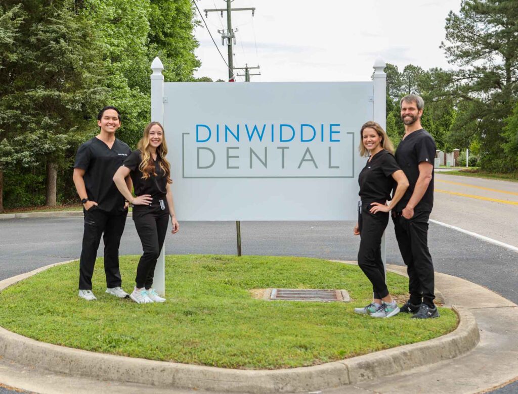 dinwiddie doctors standing in front of Dinwiddie Dental sign